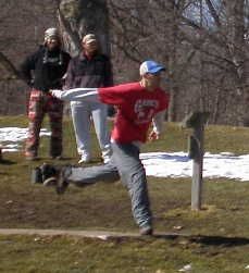 Disc golfer throws from tee